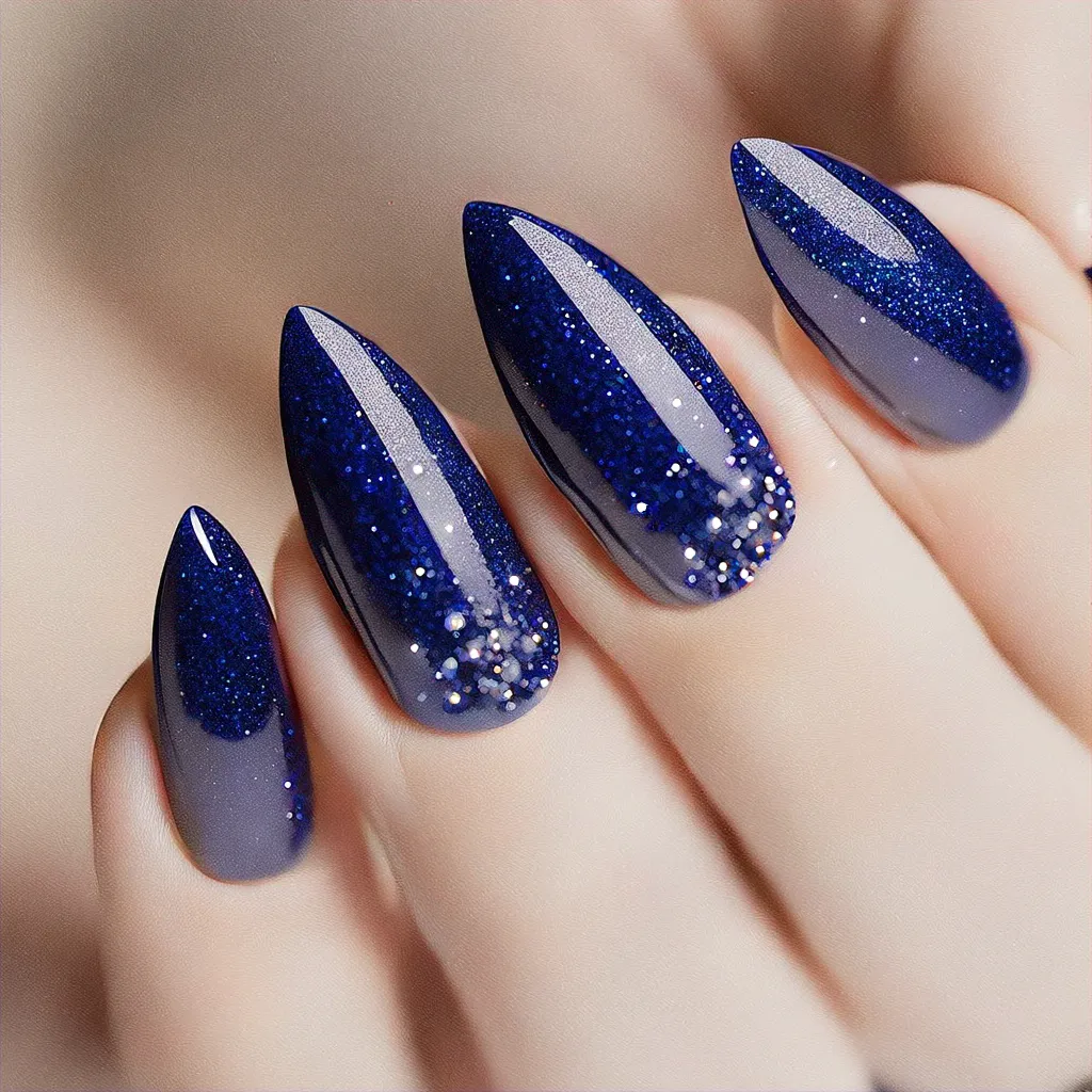 Exquisite royal blue stiletto Christmas nails. A must-try elegant ombre glitter style for fair skin tones.