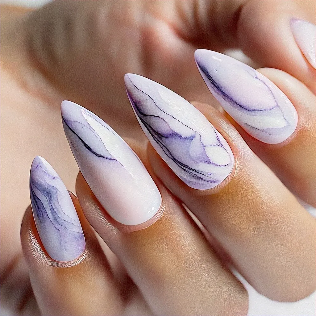 Medium-olive skin with stiletto-shaped tan nails. A summer theme featuring stylish lavender marble techniques.