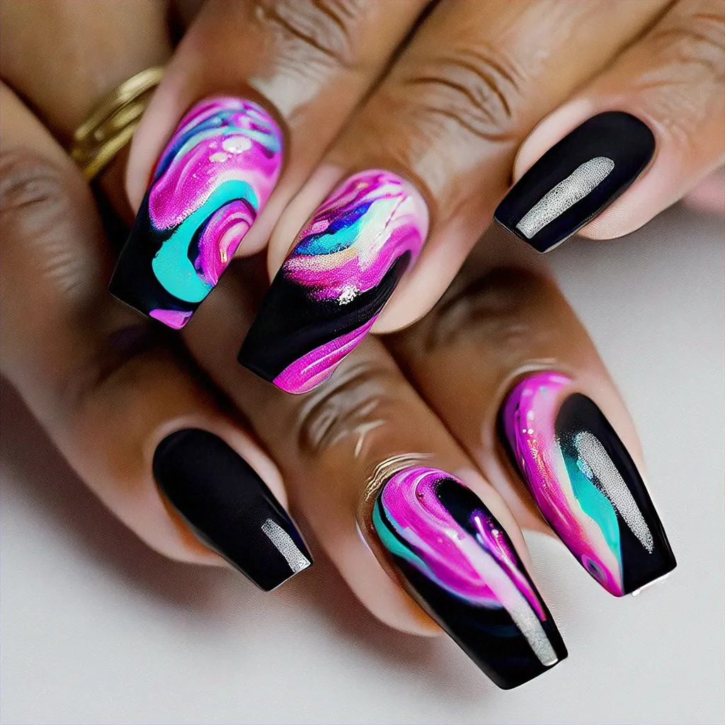 A vibrant, party-themed swirl technique on coffin-shaped nails in shades of black & pink, perfect for deep skin tones.