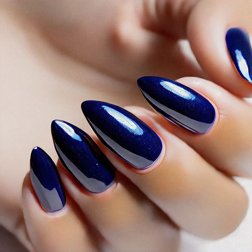 Dive into summer with these elegant stiletto-shaped chrome blue nails, perfect for medium-olive skin tones.