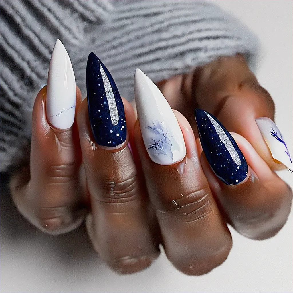Deep skin toned blue and white stiletto nails, with spooky winter theme using dip technique.