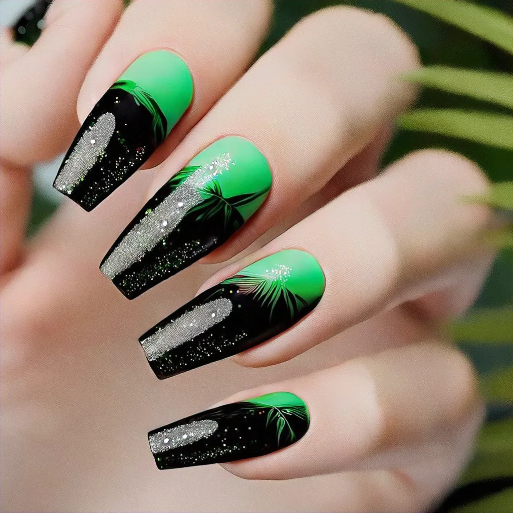 Sport a tropical beach-themed coffin-shaped manicure with glittery green and black hues, perfect for light skin tones.