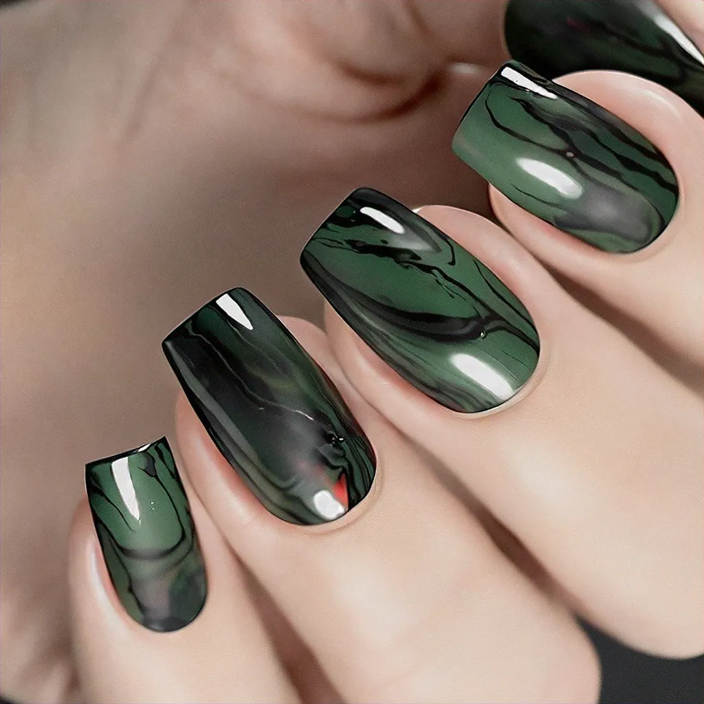 Medium-olive skin enhancing oval nails with green and black marble technique. Perfect for an unconventional birthday theme.