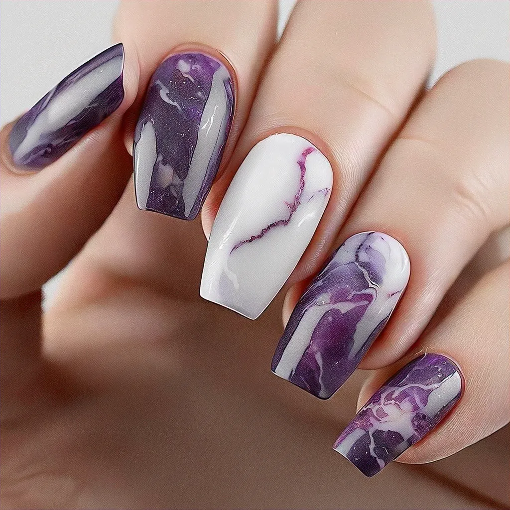 Grace your nails with purple and white gothic marble art, ideal for Easter. Best on medium-olive coffin shaped nails.