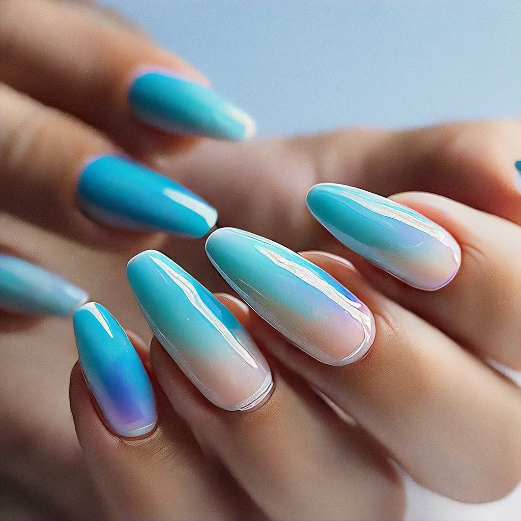 Baby blue abstract beach-themed coffin nail art using cat eye technique for light skin tones.