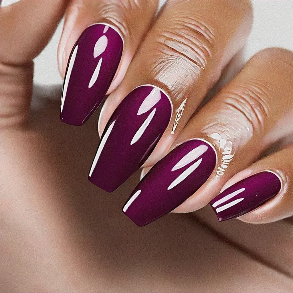 A lively party-themed coffin shaped red and white manicure with lilac swirls, ideal for deep skin tones.