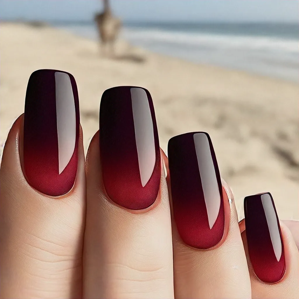 Light skin tone highlights a burgundy beach-themed design; gothic in style with edgy coffin-shaped & ombre nails.