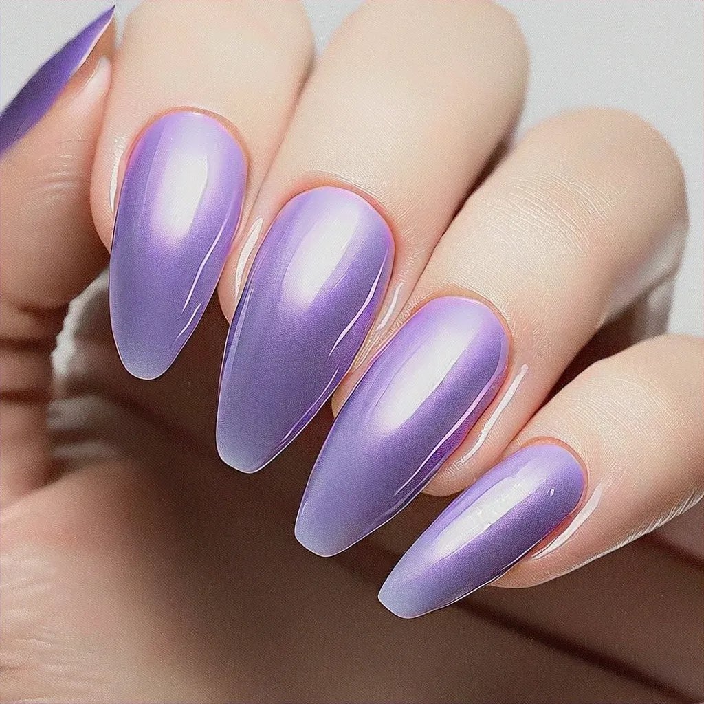 Step up your Easter look with dark purple coffin shaped nails with chromed lilac style on a medium-olive skin.