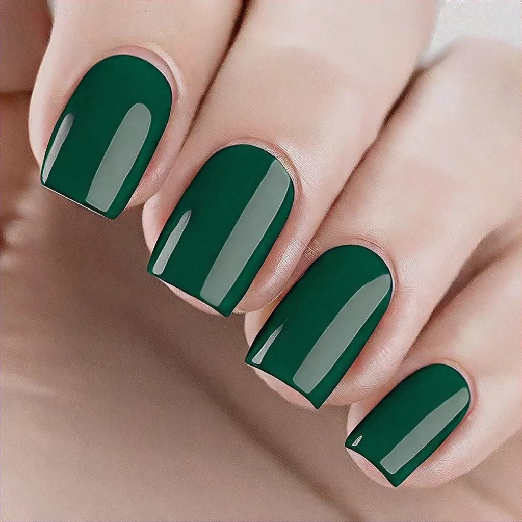 Square nails with a minimalist Halloween theme in emerald green, featuring French tip technique for fair skin.