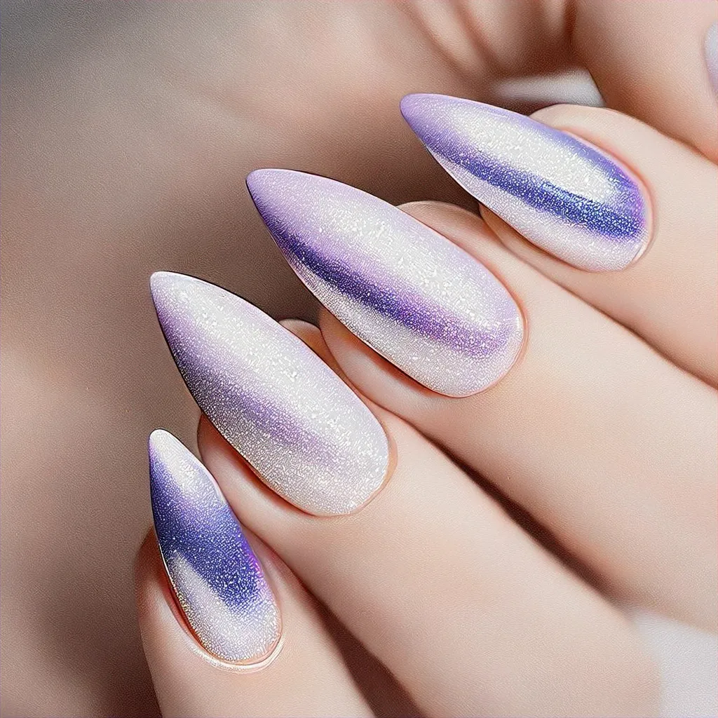 Metallic stiletto nails styled in a lavender ombre theme, perfect for holidays on light skin tones.