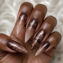 Deep skin tone foil stiletto nails in brown. Styled with winter-themed ombre dip powder technique.